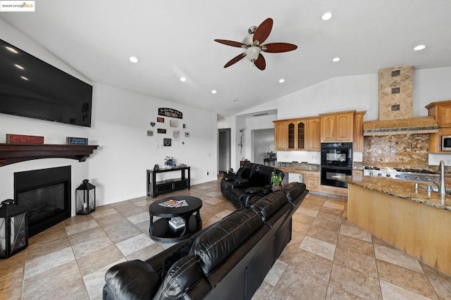 living room with ceiling fan and lofted ceiling