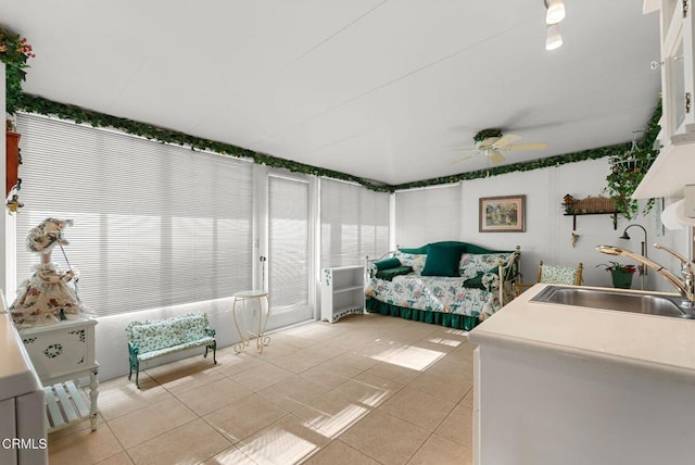 sunroom / solarium with sink and ceiling fan