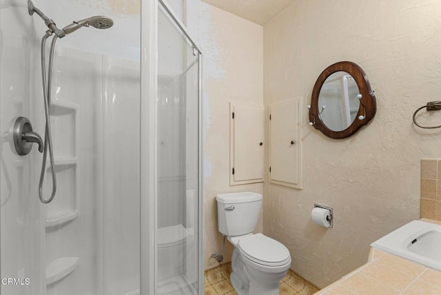 bathroom featuring toilet and a shower with shower door