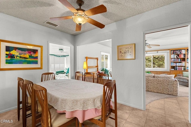 dining room featuring ceiling fan and a textured ceiling