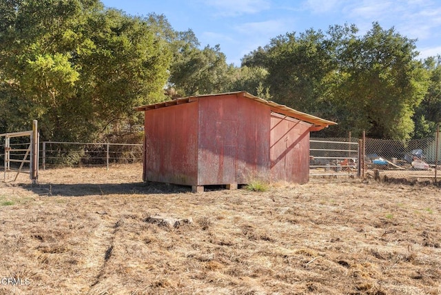 view of shed featuring fence