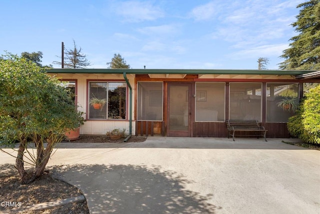 back of house featuring a sunroom