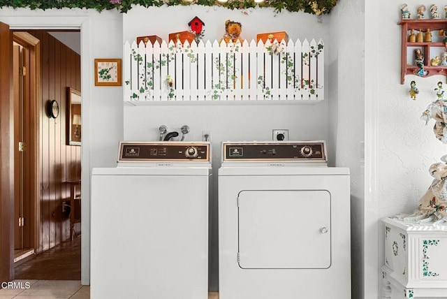 washroom with separate washer and dryer, laundry area, and tile patterned floors