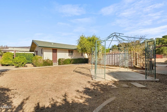 exterior space with fence and a patio area