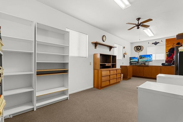 carpeted living area featuring a ceiling fan