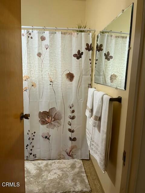 bathroom featuring curtained shower