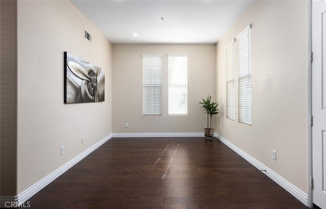 empty room with dark hardwood / wood-style flooring