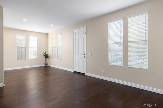 spare room featuring dark hardwood / wood-style floors