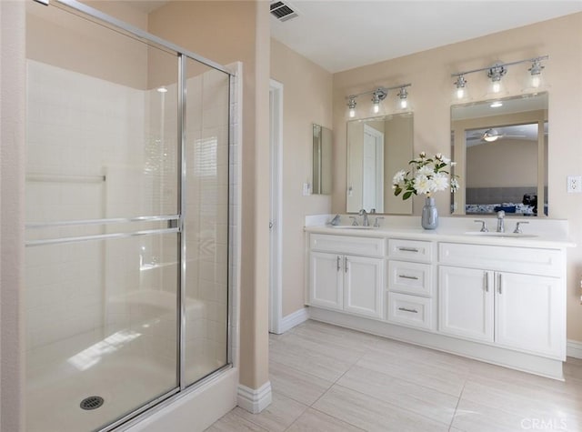 bathroom featuring vanity and a shower with shower door