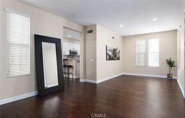 empty room with dark wood-type flooring