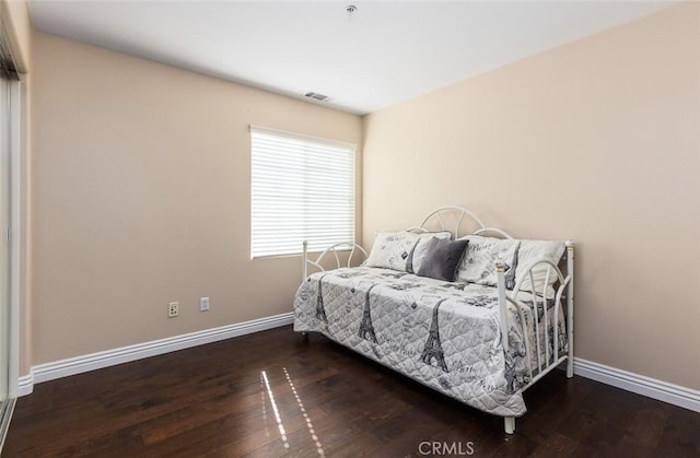 bedroom featuring dark hardwood / wood-style flooring