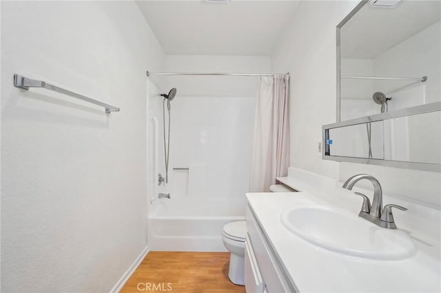 full bathroom with hardwood / wood-style flooring, shower / tub combo with curtain, vanity, and toilet