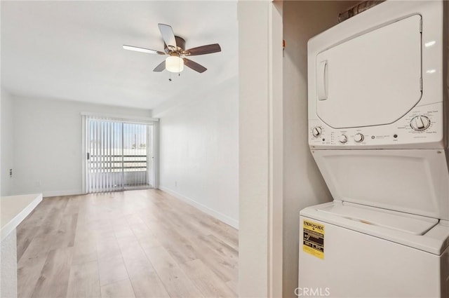 laundry area with light hardwood / wood-style flooring, stacked washer and clothes dryer, and ceiling fan