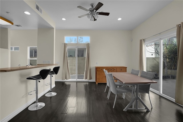 dining area featuring dark hardwood / wood-style flooring, ceiling fan, and a healthy amount of sunlight