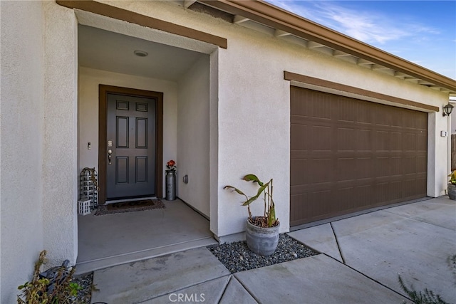 doorway to property featuring a garage