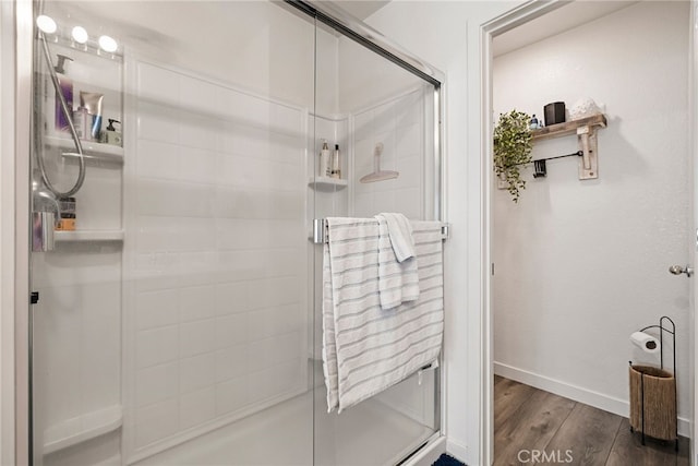 bathroom featuring wood-type flooring and walk in shower