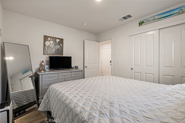 bedroom featuring hardwood / wood-style flooring and a closet