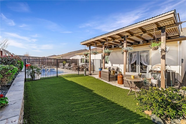 view of yard featuring a fenced in pool, a patio area, and french doors