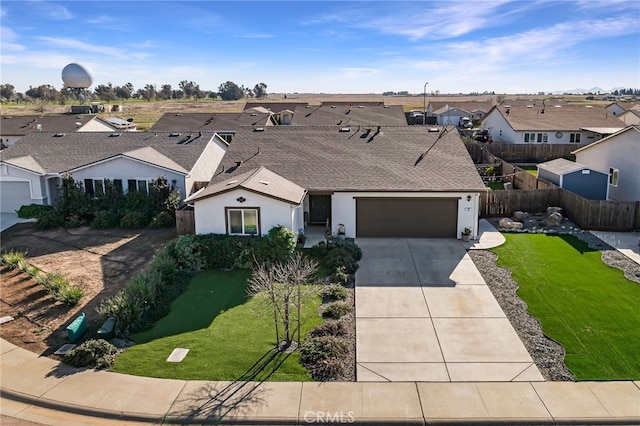 view of front of house featuring a garage and a front yard