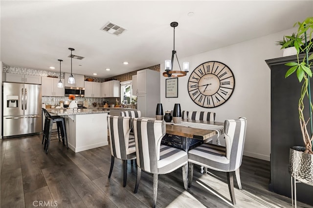 dining space featuring dark hardwood / wood-style flooring