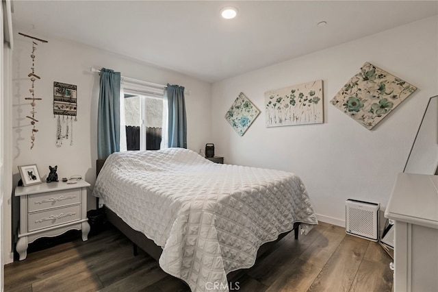 bedroom with dark wood-type flooring