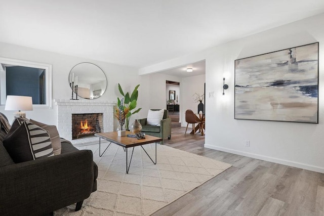 living room featuring a fireplace and light hardwood / wood-style floors