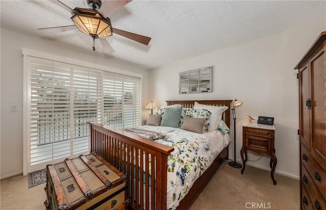 bedroom featuring ceiling fan, access to exterior, light carpet, and a textured ceiling