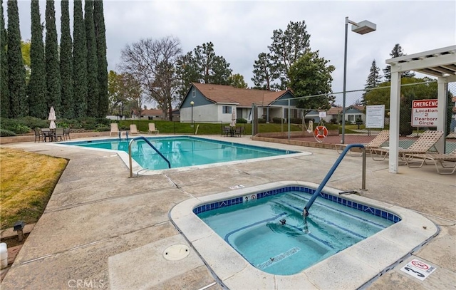 view of pool featuring a patio and a community hot tub