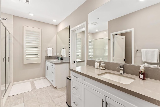 bathroom featuring vanity and a shower with door