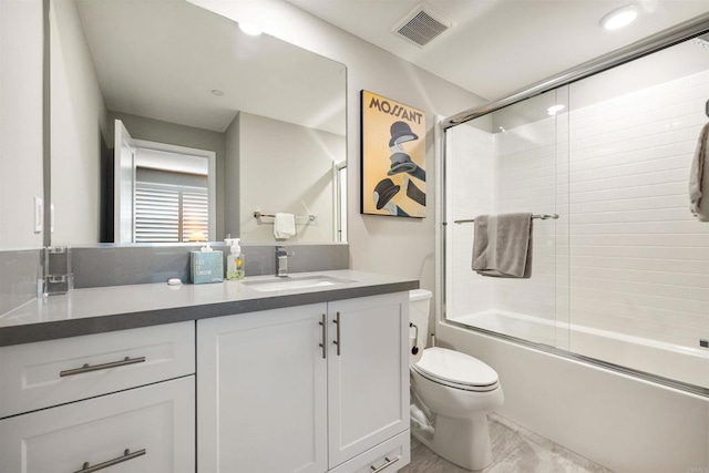 full bathroom with toilet, vanity, and shower / bath combination with glass door