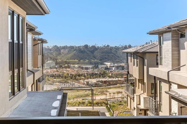 exterior space featuring a balcony and a mountain view