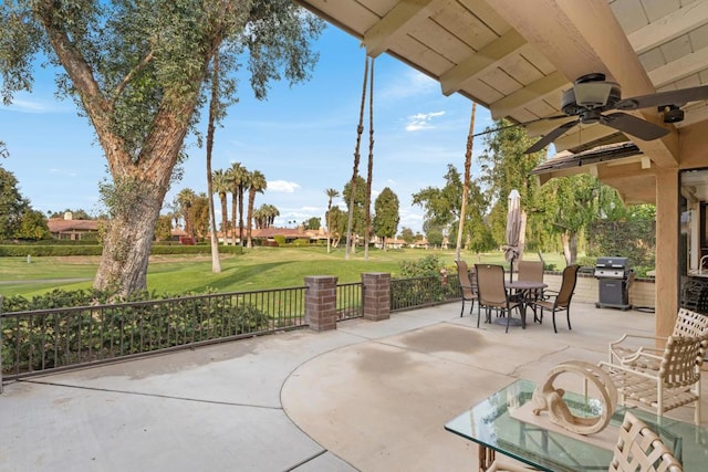 view of patio featuring area for grilling and ceiling fan