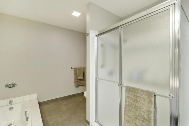 bathroom featuring tile patterned flooring, plus walk in shower, and toilet