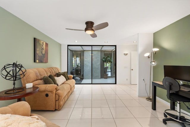 living room featuring ceiling fan, floor to ceiling windows, and light tile patterned floors