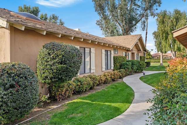 view of property exterior with a yard