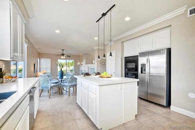 kitchen featuring pendant lighting, white cabinetry, stainless steel fridge, and a kitchen island