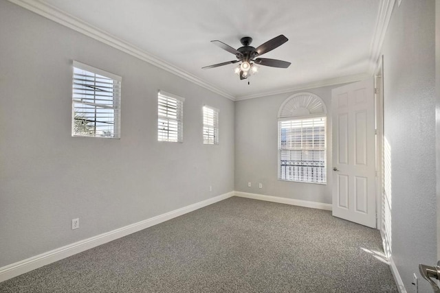 carpeted spare room with ceiling fan and ornamental molding