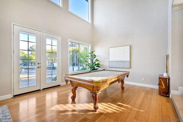 playroom featuring a high ceiling, billiards, light hardwood / wood-style floors, and french doors