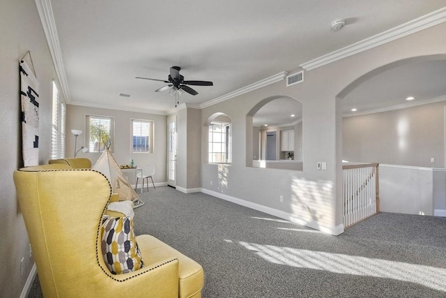 living room with crown molding, carpet, and ceiling fan