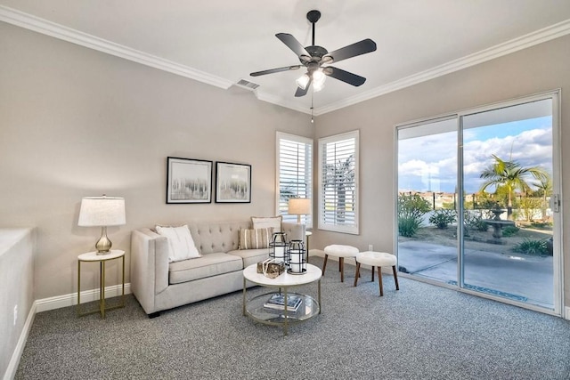 carpeted living room with crown molding and ceiling fan