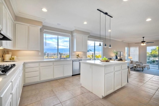 kitchen featuring pendant lighting, sink, white cabinetry, stainless steel appliances, and a kitchen island