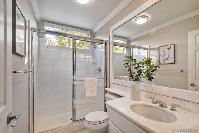 bathroom with vanity, ornamental molding, toilet, and walk in shower