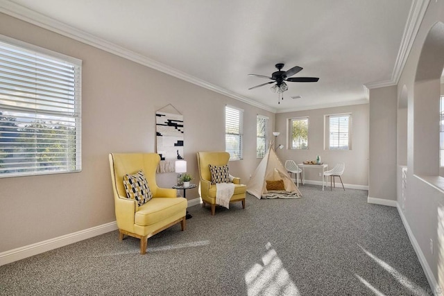 living area featuring crown molding, carpet, and ceiling fan