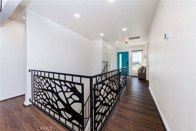 hallway with dark hardwood / wood-style flooring