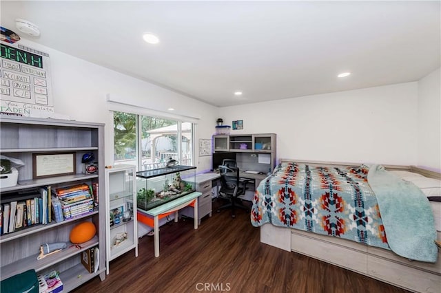 bedroom with dark hardwood / wood-style floors