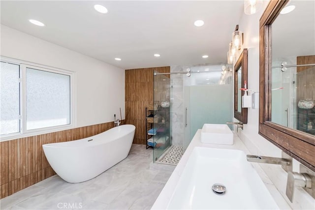 bathroom with vanity, plus walk in shower, and wood walls