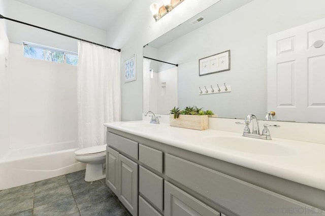 full bathroom with vanity, shower / bath combo, tile patterned floors, and toilet