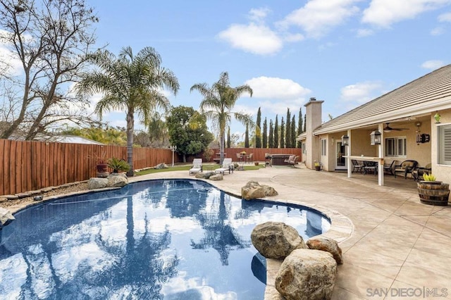 view of pool with ceiling fan and a patio area