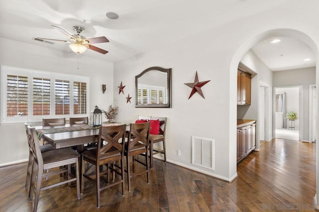 dining room with dark wood-type flooring and ceiling fan