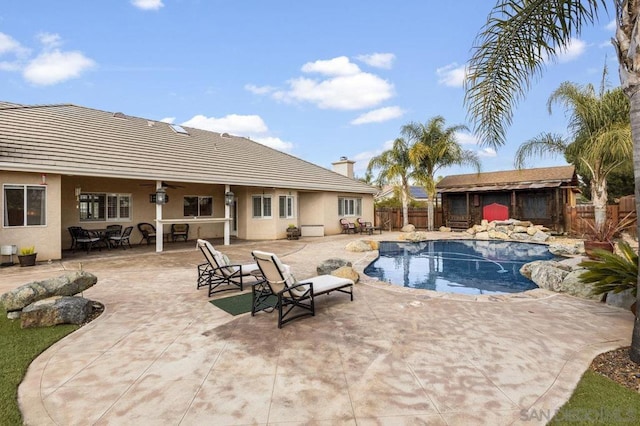 view of swimming pool with a patio and ceiling fan